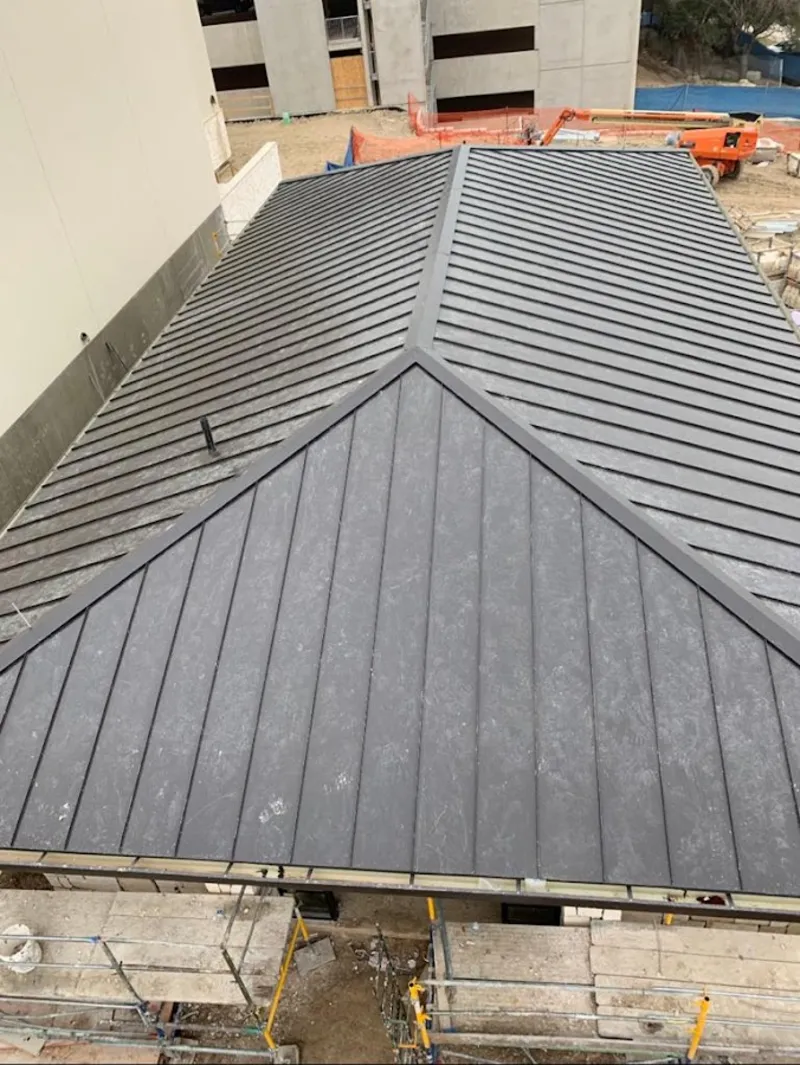 Commercial metal roof construction with crane equipment in Weisenberg