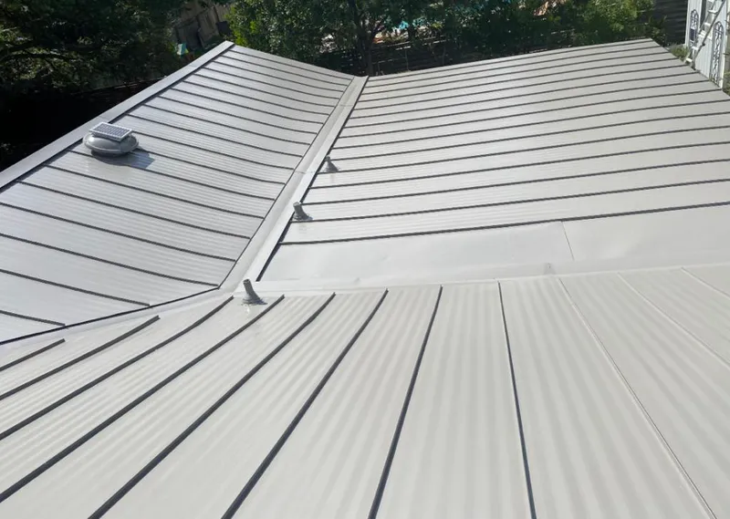 Solar attic fan installed on a metal roof for Roof Ventilation in Weisenberg